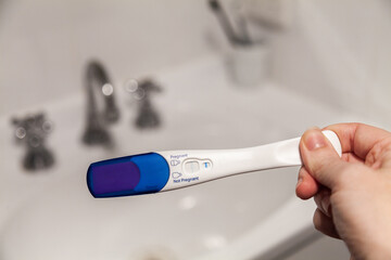 Positive pregnancy test showing blue line