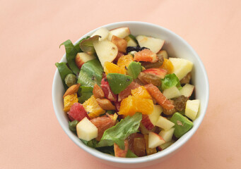 Sliced fruit salad mixed in bowl,