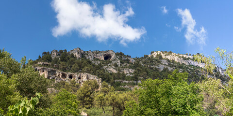 Mountain cliffs with caves in Fontaine-de-Vaucluse, Provence, France