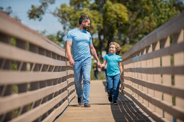 Fototapeta na wymiar cheerful father walking with his son outdoor, friendship