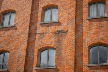 Fototapeta na wymiar old red brick wall windows part residential 