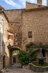 Crestet narrow street of typical provencal old town, medieval village in Vaucluse, France, Europe