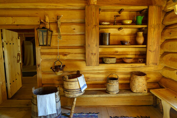 Wooden house interior with very old wooden items such as buckets and containers.
