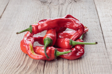 Ugly Chili pepper on a gray wooden background. Selective focus.