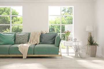 White living room with sofa and summer landscape in window. Scandinavian interior design. 3D illustration