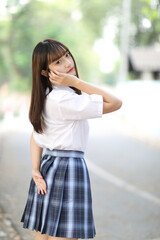 beautiful asian japanese school girl uniform looking at park outdoor