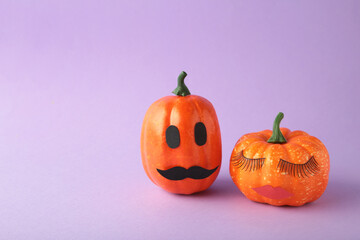 Halloween pumpkin with make up. Minimal Holiday season concept background. Man and woman