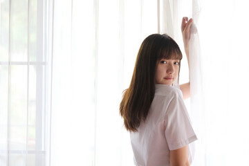 Naklejka premium Portrait japanese school girl uniform in white tone bed room