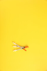 Syringe vaccine isolated in yellow background