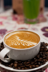 white cup of coffee with brown beans
