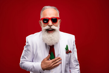 Photo of old happy positive old man wear three piece suit good mood laugh joke isolated on red color background