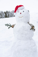 child builds a snowman in the winter in the yard. concept of winter games with snow for children