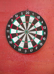 aiming with darts on a dartboard, indoor sports
