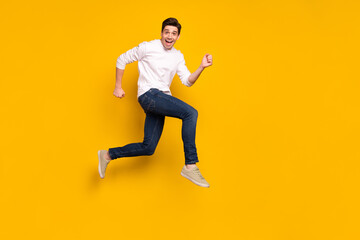 Fototapeta na wymiar Full length body size photo man jumping up running on sale isolated vivid yellow color background