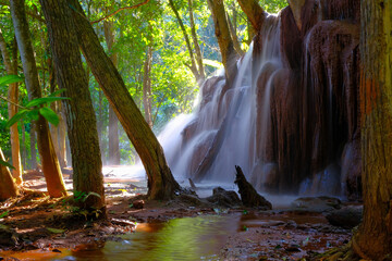Beautiful a small waterfall with water flow in the tropical rainforest. Pawai Waterfall, Phop Phra District, Tak Province, Thailand.