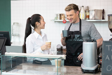 barista and owner tasting a cup of coffee before opening in coffee shop