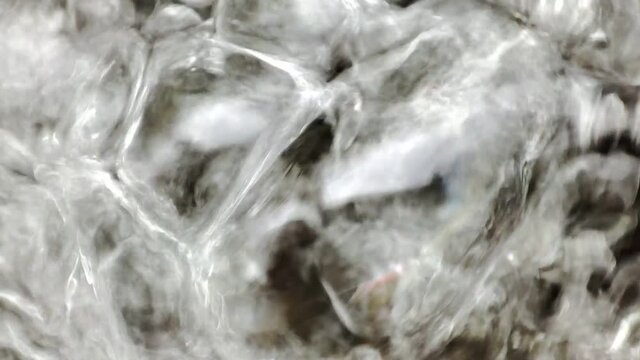 Close-up of the bubbling in the water the flow of the river in a macro approximation with the sound of flowing water