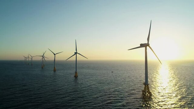 Beautiful sunset background the wind power generators on the sea, Offshore wind turbine in Jeju Island. South Korea. 제주 해안 풍력발전, 해상풍력, 바다, 풍력발전기