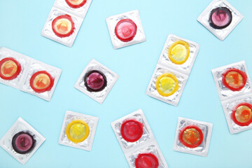 Colorful condoms on blue background