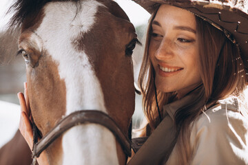 Young happy woman with horse at ranch - obrazy, fototapety, plakaty