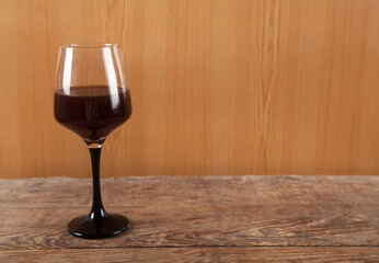 Glass and wine,  isolated on wooden background.