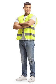 Full length portrait of a smiling security officer in a safety vest standing with crossed arms