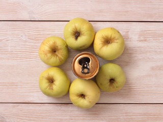 Big green apple on a kitchen scale on a wooden table