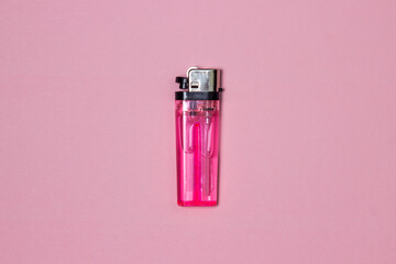 Pink lighter on a pink background. Cheap plastic lighter - obrazy, fototapety, plakaty