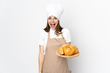 Young woman in chef uniform isolated on white background with surprise facial expression