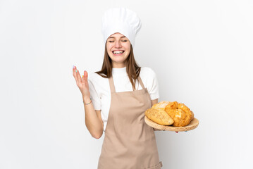Young woman in chef uniform isolated on white background laughing