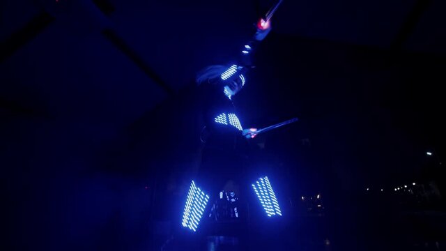dancing woman illuminated by neon and ice light. Dancing at a party. Dance show.