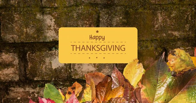 Animation of happy thanksgiving text over bricks with autumn leaves