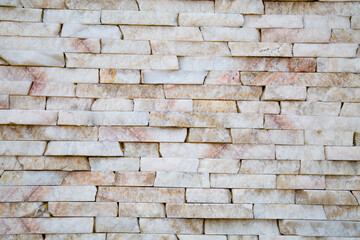 The background of the wall is made of strips of natural honey onyx with a beautiful pattern of white and pink stone. Backgrounds texture design.