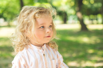 Handsome boy with blue eyes and curly blond hair