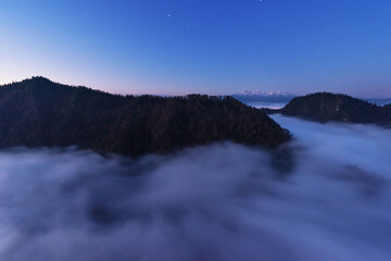 Golden autumn in the mountains with morning mists and yellow-red leaves on the trees
