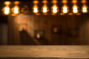 Empty dark wooden table in front of abstract blurred bokeh background of restaurant . can be used for display or montage your products.Mock up for space