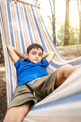 confident young caucasian boy in hammock