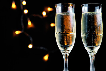 Two bubbly champagne glasses, celebration theme.