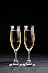 Two bubbly champagne glasses, celebration theme.