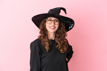Fototapeta premium Young caucasian woman celebrating halloween isolated on pink background with glasses and happy