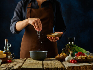 The chef salt the mustard sauce. Levitation. Ingredients for making a classic Caesar salad. Restaurant, hotel, cafe, home cooking, cookbook.
