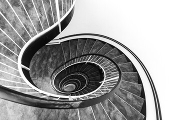 Sprial staircase forming a beautiful shell pattern with white wall for copy space