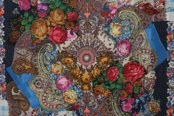 Patchwork handmade carpet, detail. Floral ornament. Patchwork handmade carpet made of russian traditional national folk Pavlovo Posad shawl, scarf. Ethnic decor, colorful patchwork. Handicraft, craft