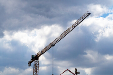 Construction tower crane on blue sky background