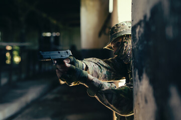 Airsoft player aiming with a replica pistol