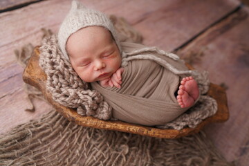Sleeping newborn boy in the first days of life. Newborn photo session.