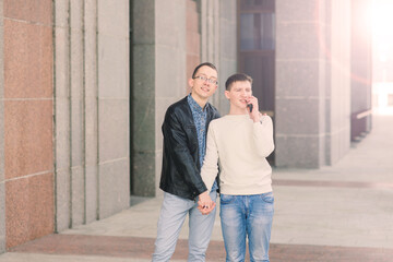 Cute gay couple in the city, tender gentle kissing, smiling
