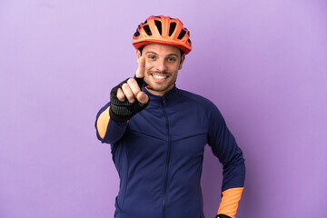 Young Brazilian cyclist man isolated on purple background showing and lifting a finger