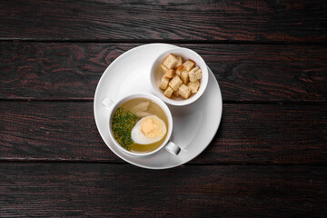 Asian noodle soup, ramen with chicken, vegetables and egg in white bowl