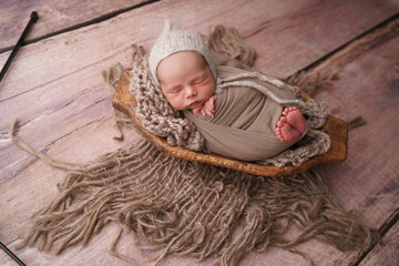 Sleeping newborn boy in the first days of life. Newborn photo session. - obrazy, fototapety, plakaty